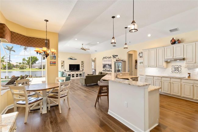 Island kitchen, cafe' w/ aquarium glass window & family room. | Image 9