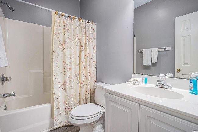 Bathroom featuring shower / bath combo with shower curtain and vanity | Image 18