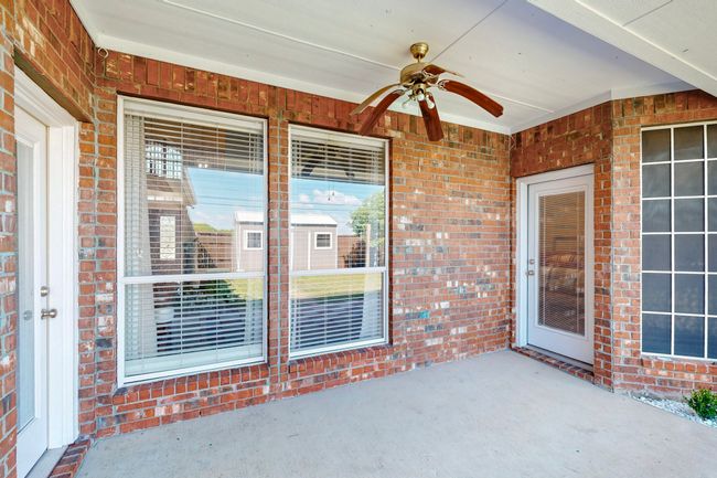 View of patio featuring a ceiling fan | Image 32