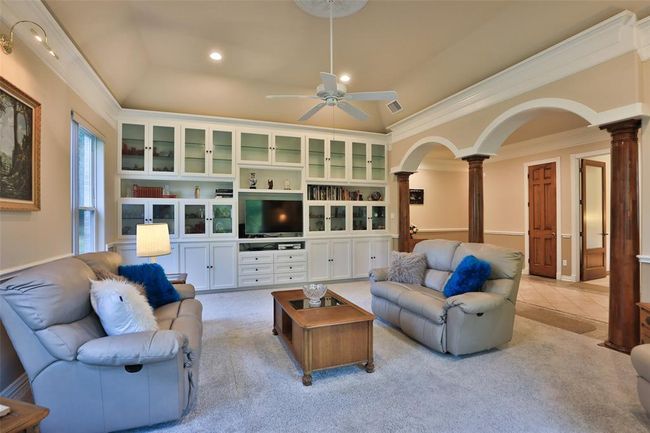Another view of this spectacular living room with wall to wall built in entertainment center with glass fronted display cabinets and plenty of storage! | Image 14