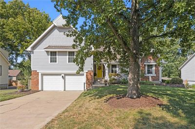 View of front facade with a garage and a front lawn | Image 2