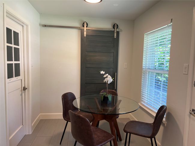 Cozy breakfast area with separate utility room and barn door | Image 9