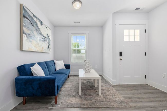Living area with visible vents, plenty of natural light, baseboards, and wood finished floors | Image 25