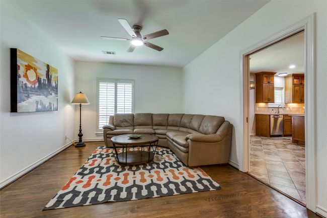 Every room in the house has plantation shutters! The oak flooring continues into the den. There's a pocket door between the den and the kitchen... | Image 7
