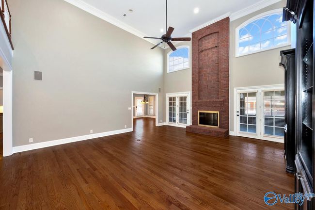 Wood flooring, built in cabinetry, fireplace, extra high ceilings, recessed lighting, crown molding, Double doors open to enclosed porch | Image 6