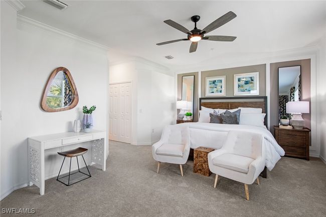 Carpeted bedroom with visible vents, baseboards, crown molding, and a ceiling fan | Image 9