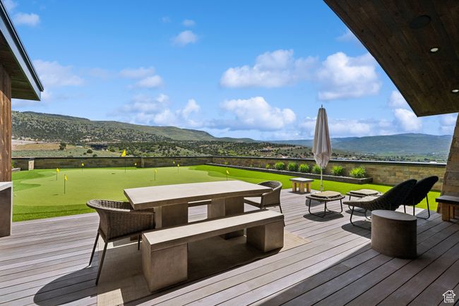 Wooden deck with a putting area and a mountain view | Image 117