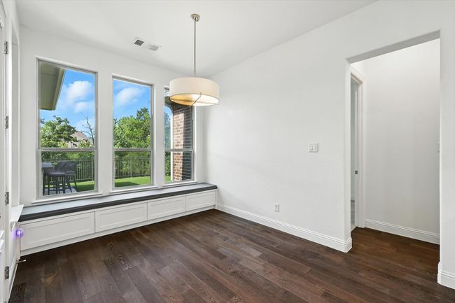 Unfurnished dining area featuring dark wood-type flooring and baseboards | Image 14