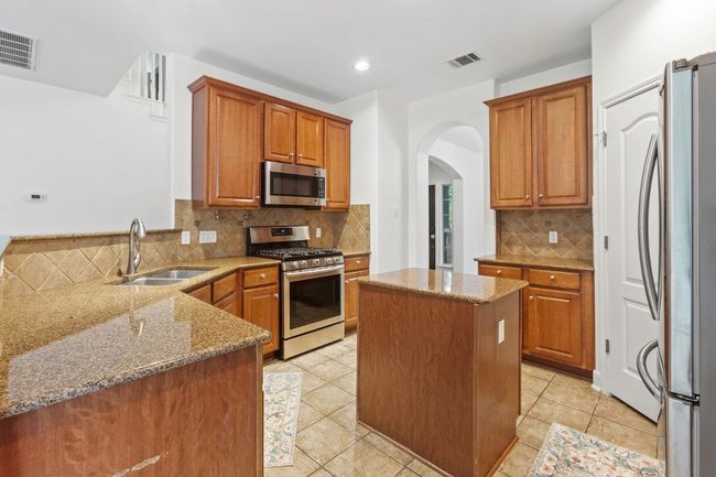 Kitchen featuring tons of cabinets | Image 9