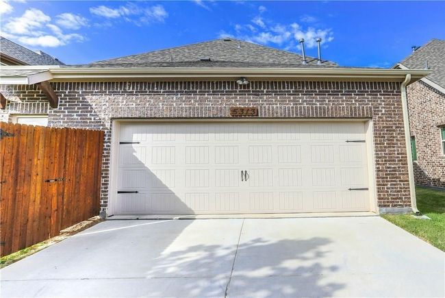 Garage featuring concrete driveway | Image 33
