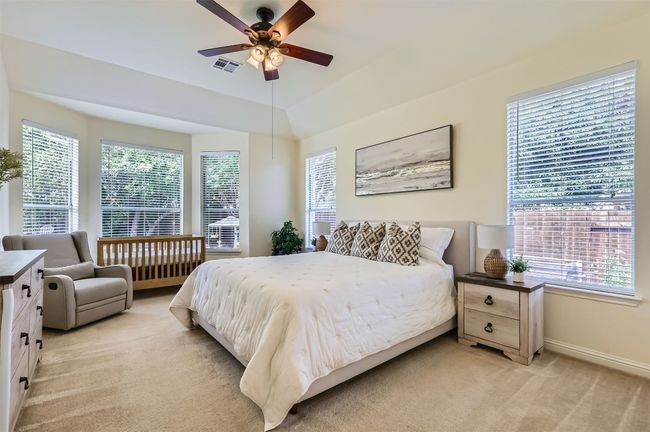 Primary bedroom with backyard-facing bay window; room is currently accommodating a newborn setup. | Image 15