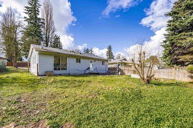 Rear view of property with a lawn and a fenced backyard | Image 16