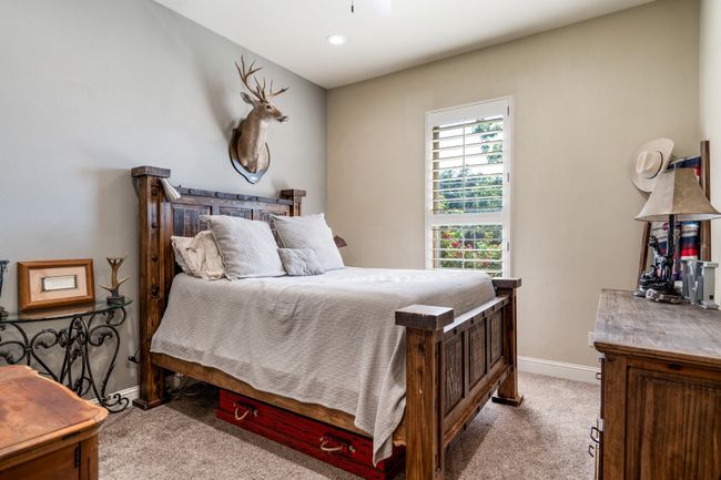 Bedroom featuring light carpet | Image 27