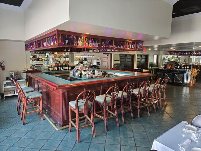 The up Stairs Lounge In The Lake Room Overlooking Pool And Lake And Water Fountain | Image 7