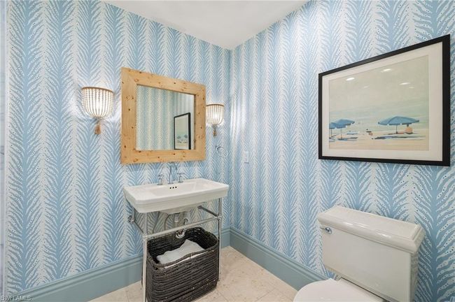 Half bath featuring toilet, a sink, wallpapered walls, and baseboards | Image 37