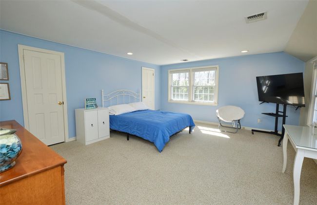 Bedroom featuring carpet flooring, visible vents, baseboards, recessed lighting, and vaulted ceiling | Image 17