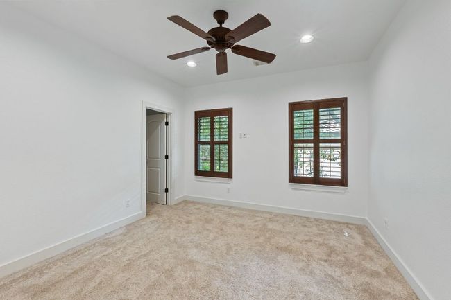 Unfurnished room featuring light colored carpet, ceiling fan, and recessed lighting | Image 23