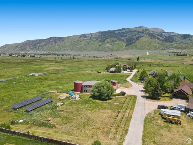 Aerial view of sparsely populated area with a mountain backdrop and agricultural land | Image 41