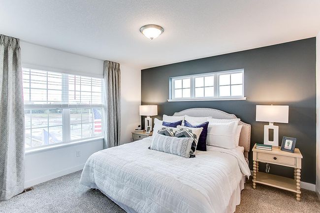 Spacious primary suite with large windows create an open and airy feel. Model picture shown. Colors and finishes may vary. | Image 9