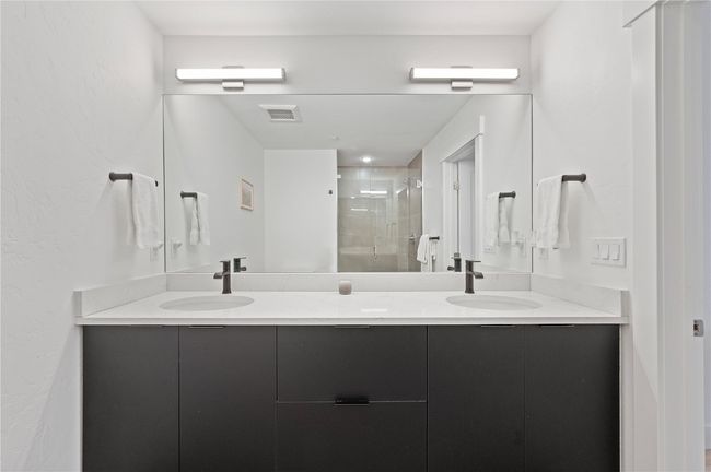 Bathroom featuring vanity and a shower with door | Image 20