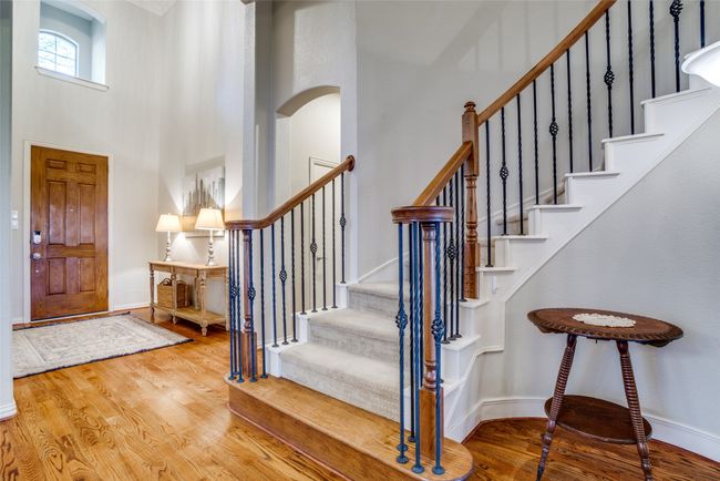 Foyer - wood finished floors, towering ceiling, and grand staircase | Image 5