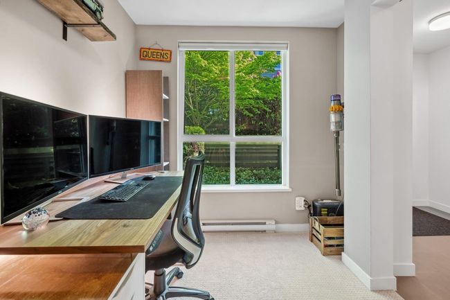 Carpeted office space featuring a baseboard radiator and baseboards | Image 34