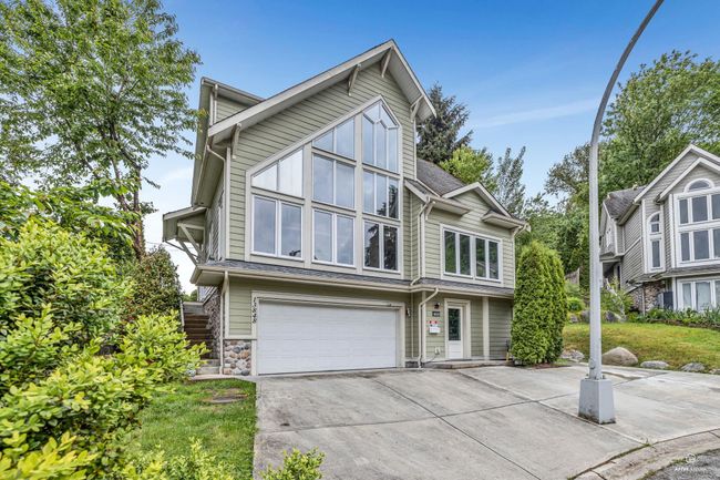 View of front of property with a garage, driveway, and stairway | Image 4
