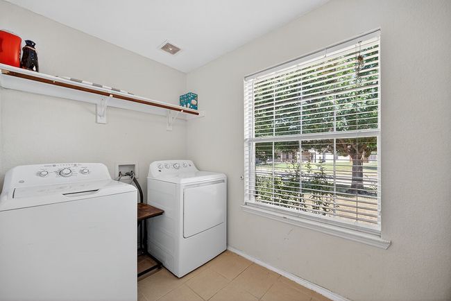 Washroom with washer and dryer, plenty of natural light, and light tile patterned floors | Image 22