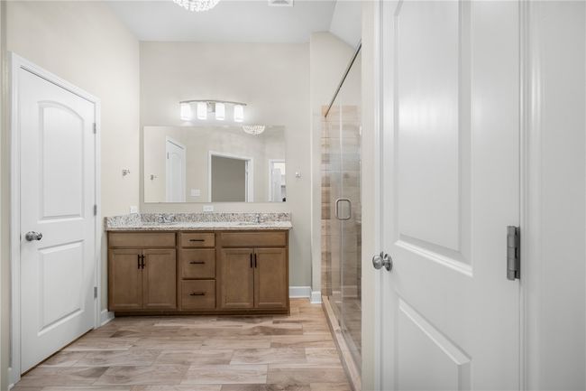 Full bathroom with double vanity and a shower stall | Image 27
