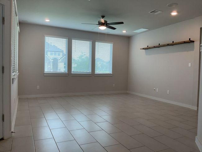 Living room featuring a ceiling fan, recessed lighting, and light tile patterned flooring | Image 11