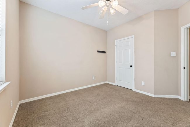 Secondary bedroom with ceiling fan | Image 29