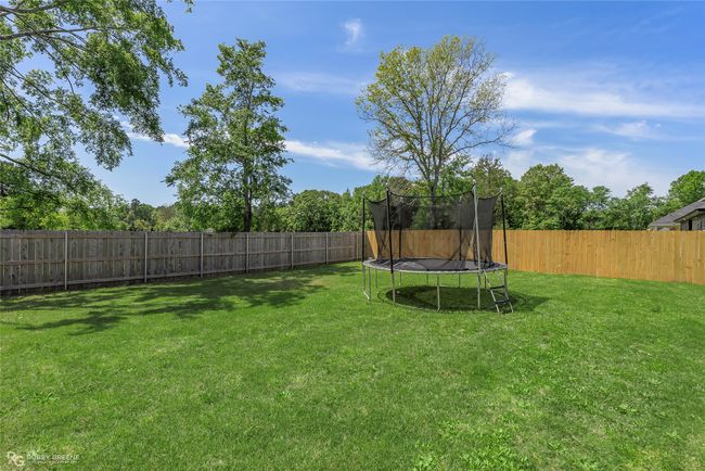 View of yard with a fenced backyard and a trampoline | Image 29