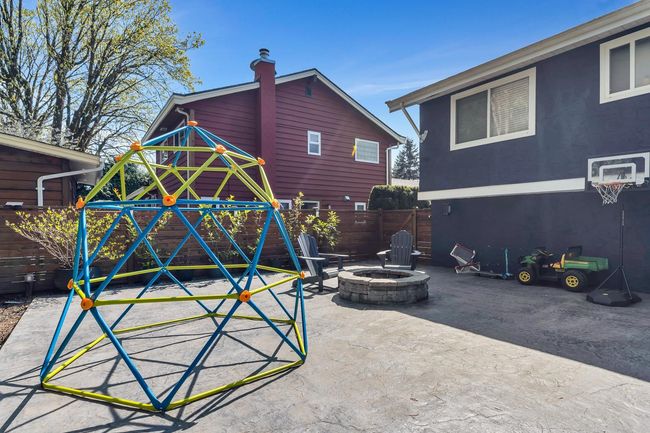 Exterior space with a patio, stucco siding, a playground, a fire pit, and fence | Image 40