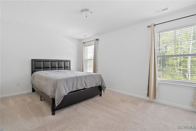 Bedroom with baseboards, carpet, and visible vents | Image 21