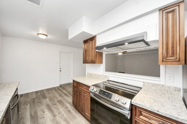 View from kitchen to breakfast nook and out the pass-through window | Image 16