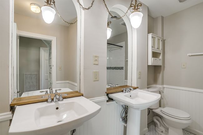 Full bathroom featuring a wainscoted wall, a shower, and tile patterned flooring | Image 12