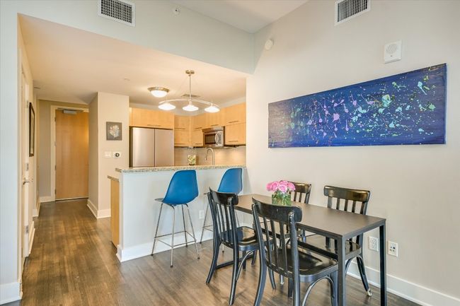 Dining room featuring dark wood finished floors, visible vents, and baseboards | Image 6