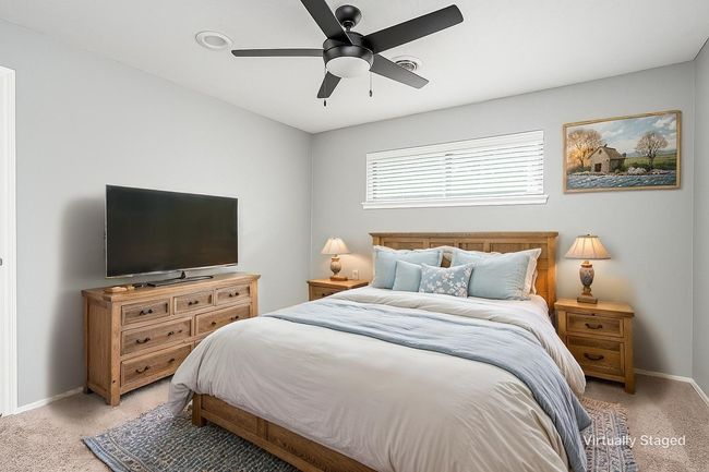 Bedroom featuring light colored carpet, baseboards, and a ceiling fan | Image 31