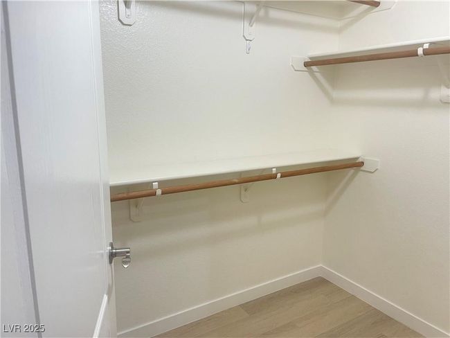 Walk in closet with light wood finished floors | Image 16