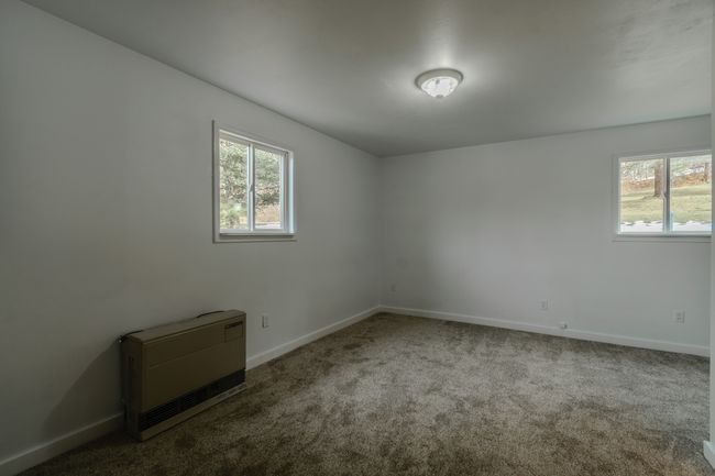 Spare room featuring carpet flooring and heating unit | Image 41