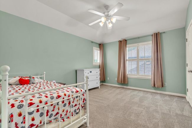 Bedroom featuring carpet, baseboards, and ceiling fan | Image 24