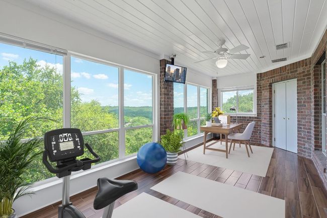 This will become one of your favorite rooms. It is the owners at-home office off of the primary bedroom with walls of glass overlooking the bluff. Not working from home, a wonderful sun room! | Image 7