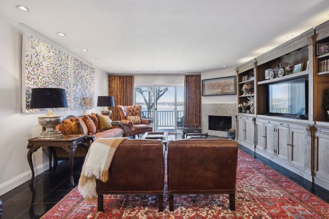 Spacious living area with amazing lake views, balcony overlooking the lake and a fireplace. | Image 14