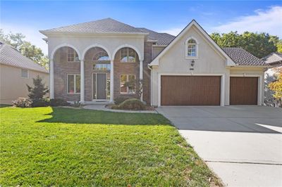 View of front of home with a front lawn and a garage | Image 3