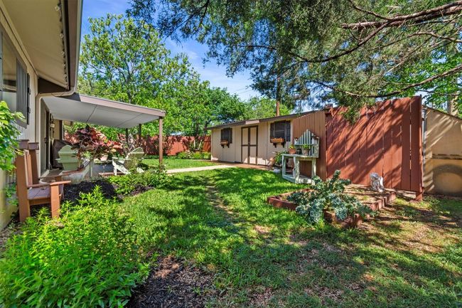 A full privacy fence surrounds the yard, making it a safe and secure place for pets or kids to play. | Image 31