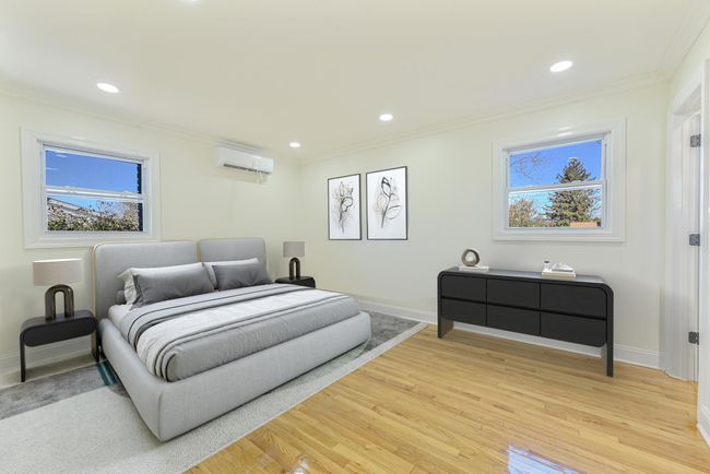 Bedroom with hardwood / wood-style flooring, ornamental molding, and a wall unit AC | Image 30