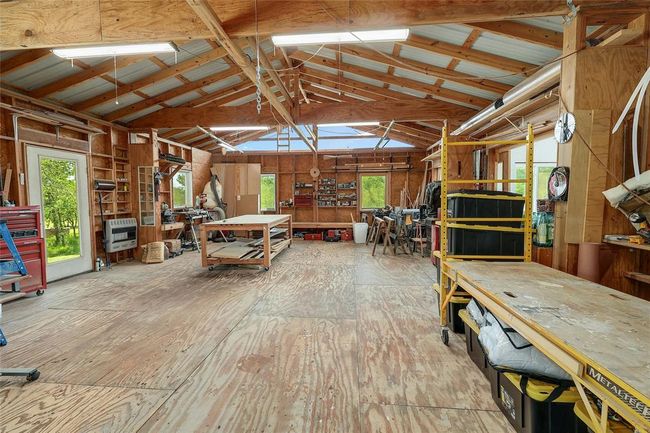Miscellaneous room with lofted ceiling, heating unit, and a workshop area | Image 26
