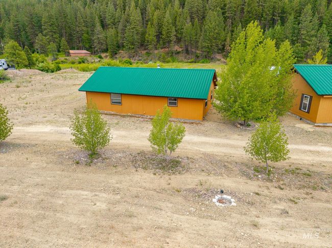 View of side of property with a metal roof and a view of trees | Image 30