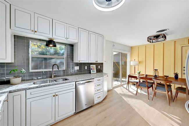 The kitchen windows provides sunlight and serene backyard views. | Image 14
