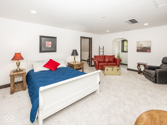 bedroom featuring carpet, arched walkways, baseboards, and recessed lighting | Image 32